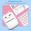 Cute printer with cartoon face on a pink keyboard and mouse pad
