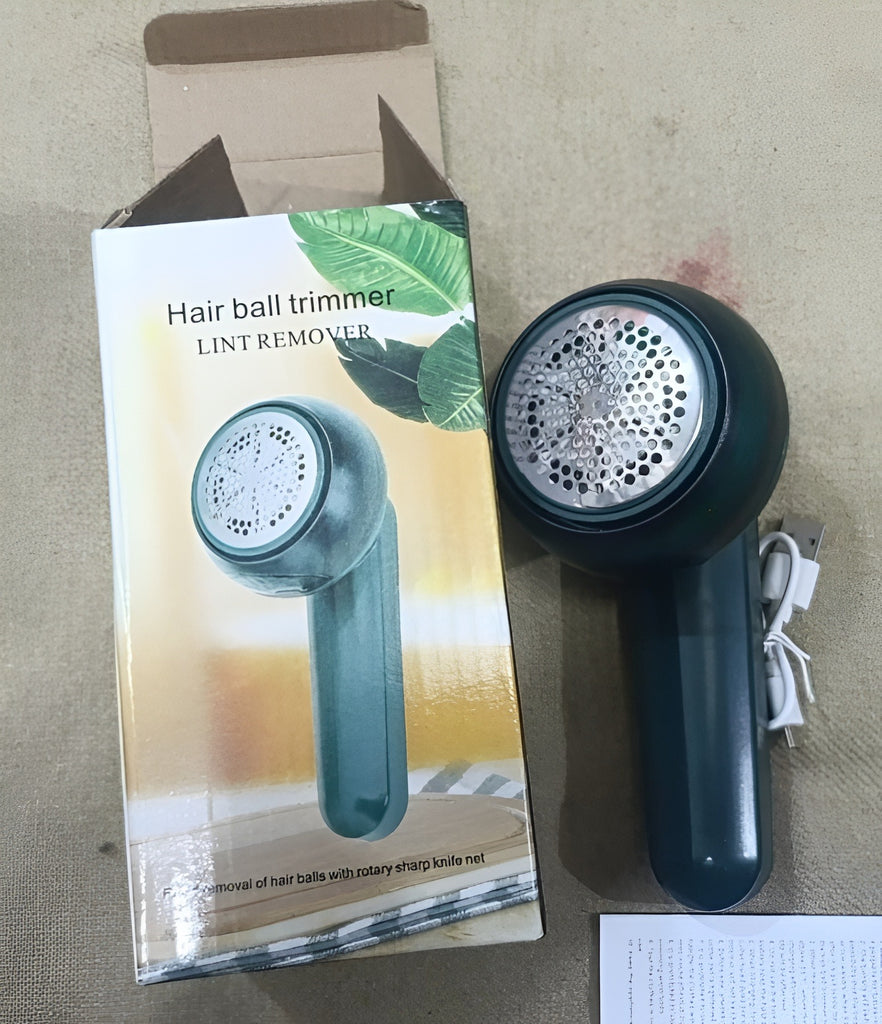 Hair ball trimmer with packaging on a beige surface